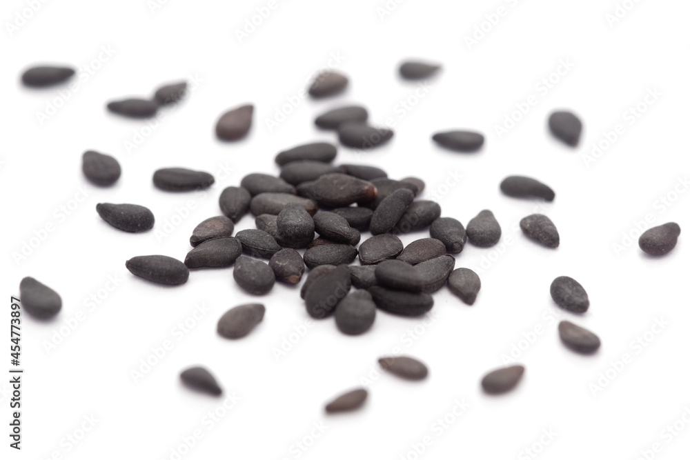 Micro close-up and details of Organic Indian Sesame seeds (Sesamum indicum) or Black Til with black shell isolated over white background. Micro close-up and details of Organic Indian Sesame seeds (Sesamum indicum) or Black Til with black shell isolated over white background.