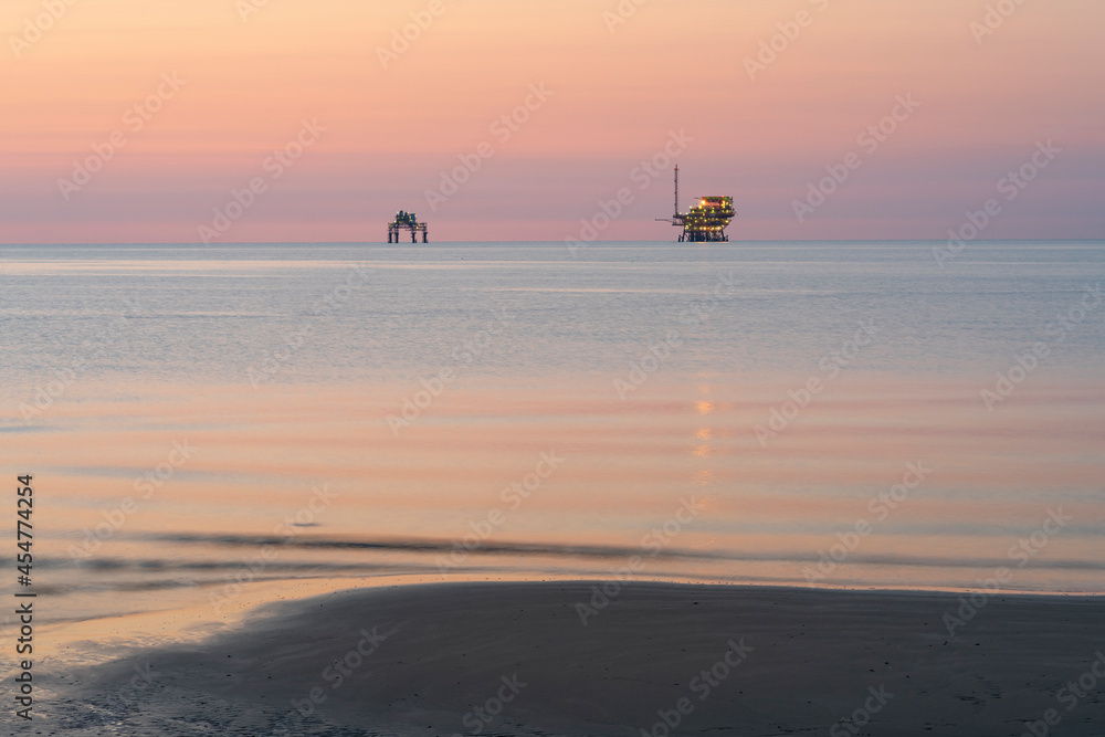 Platforms for extraction and transformation of natural gas at sunrise, Adriatic sea, ravenna, italy.