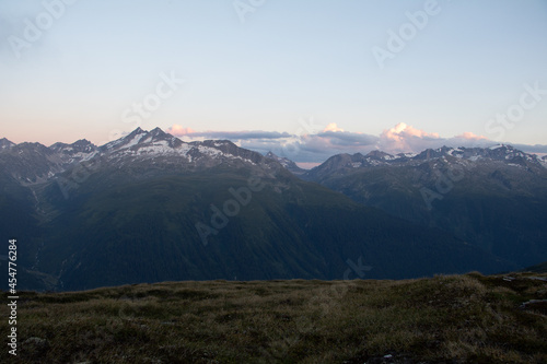 Amazing Landscape in the hearth of Canton Bernese in Switzerland. Drive on the Grimselpass. Epic scenery with the clouds and fog. Wonderful sun rays through the clouds and later an amazing sunset.