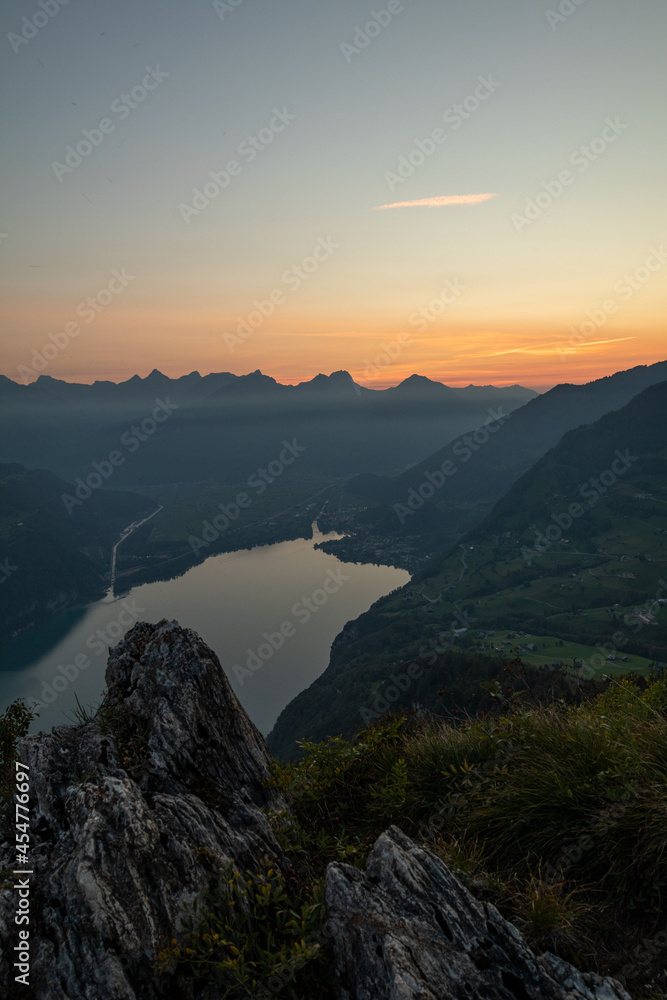 Obraz premium Amazing view over Lake Walen in the Canton Glarus, Switzerland. Wonderful sunset and sunrise in the swiss alps. This is a great place to hike and enjoy the beautiful nature in Switzerland.