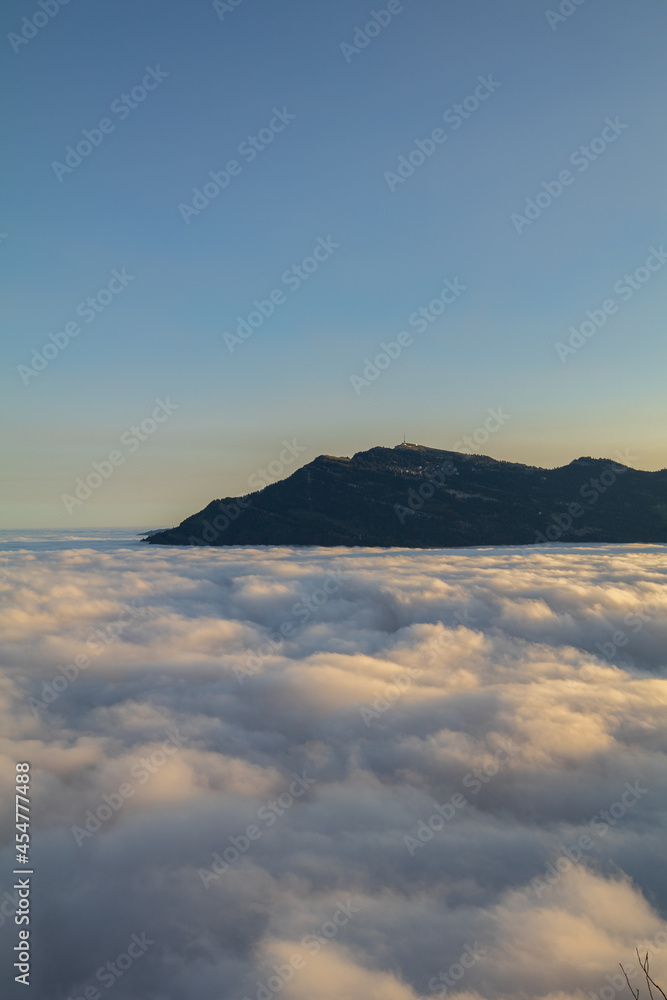 Amazing morning view over the beautiful Lake Lucerne. Epic sunset in the heart of Switzerland. Wonderful scenery with the majestic fog and the swiss alps in the background.