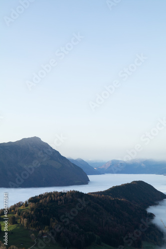 Amazing morning view over the beautiful Lake Lucerne. Epic sunset in the heart of Switzerland. Wonderful scenery with the majestic fog and the swiss alps in the background. © Philip