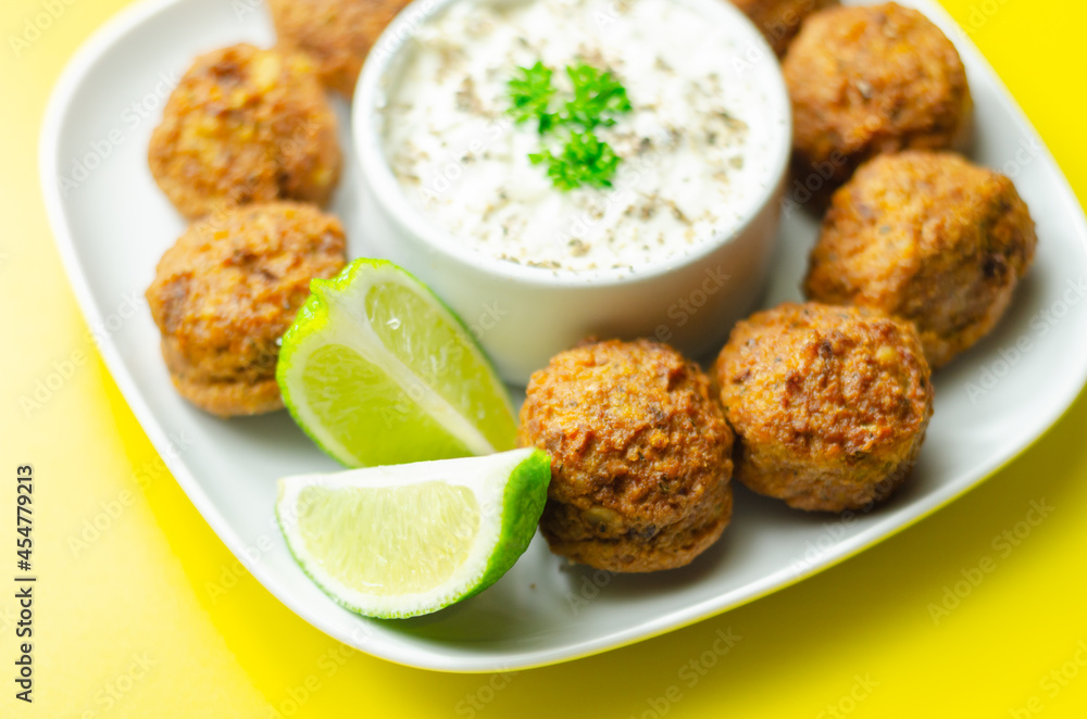 Falafels, gently spiced blend of sweet potato, chickpeas and onion with a sour dip
