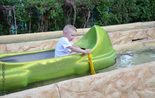 Boy on a boat in the park.