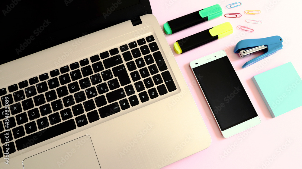 Stylish workspace with laptop computer, smartphone and modern office accessories Stylish workspace with laptop computer, smartphone and modern office accessories
