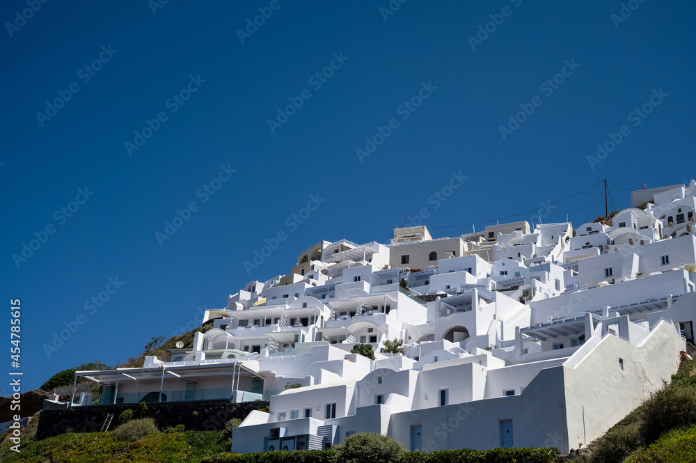 White architecture of Imerovigli on Santorini island, Greece. Luxury resort. Blue sky. Bottom view.