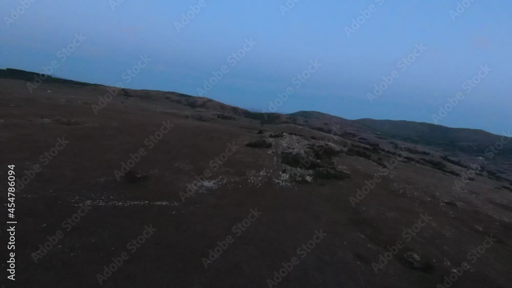 low key Aerial fpv drone shot of a herd of wild horses running on a green spring field at the sunset. low key Aerial fpv drone shot of a herd of wild horses running on a green spring field at the sunset.