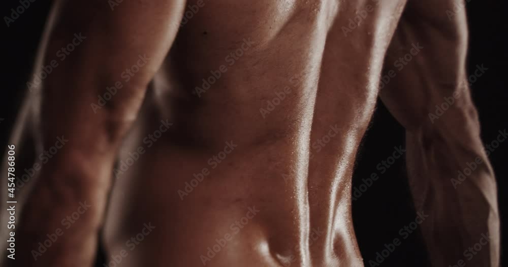 Flexing while being topless, selective focus Flexing while being topless, selective focus