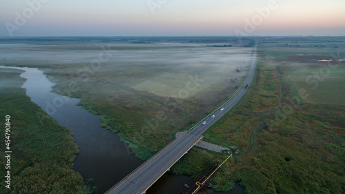 Aerial view of the fog over the road and river © Arestov Andrew