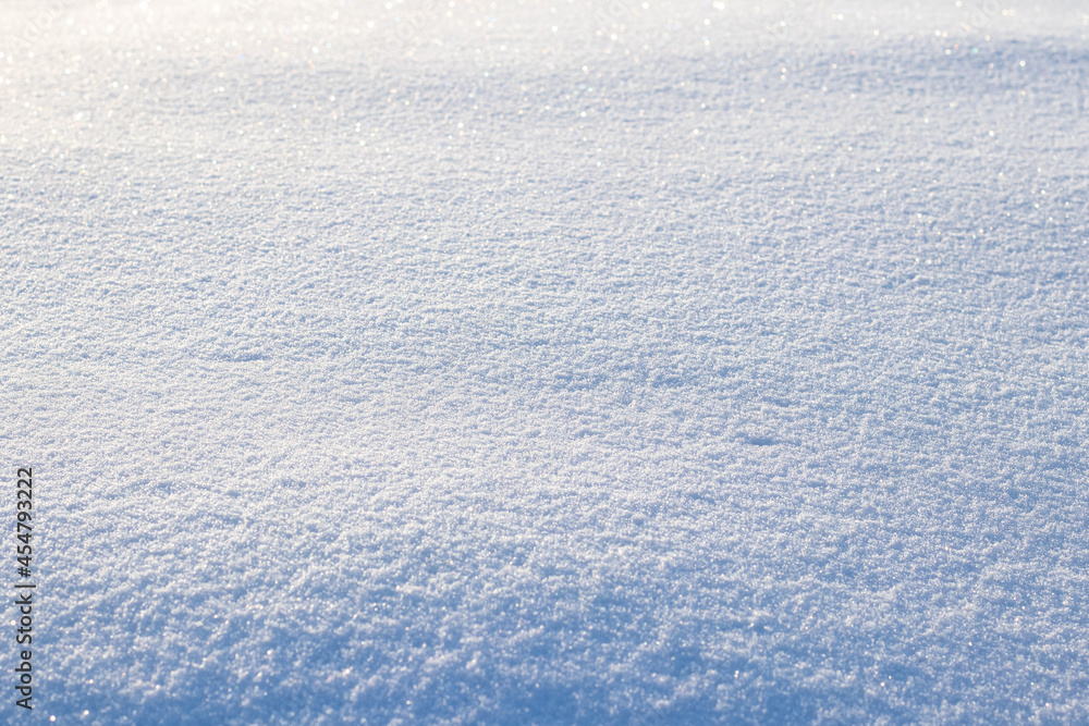 Snowy background, snowy surface with a clearly expressed texture of snow in the morning sun Snowy background, snowy surface with a clearly expressed texture of snow in the morning sun
