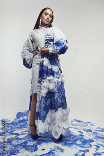 Woman in long woderful cape with blue and white waves photo