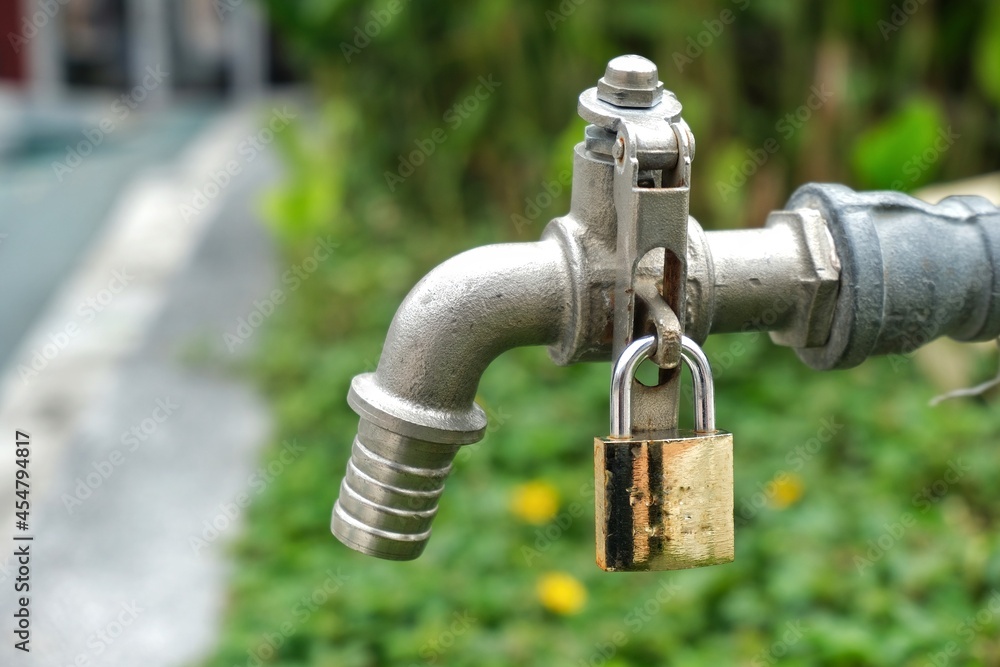 Water tap locked in a garden.
