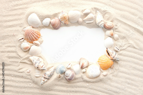 Blank white sheet of paper on white sand with seashells and stones. Message by the sea  romance  saint valenin s day  mother s  father s day. Copy space.