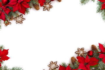 Frame of Christmas tree with balls, christmas gingerbread, flowers of red poinsettia and cones spruce on a white background with space for text. Top view, flat lay