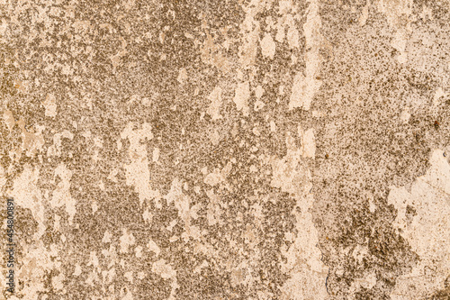 Abstract background of a wall outdoors, with white paint on cement. 