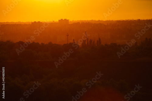 Wallpaper Mural Sunset or dawn in yellow over a small town, the silhouette of city buildings in dawn or sunset light. Torontodigital.ca