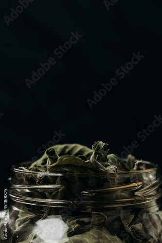 Wallpaper Mural Dry mint leaf on in a glass jar on a wooden table against a black background. Jar with mint on a wooden table. Mint for medicinal tea. Torontodigital.ca