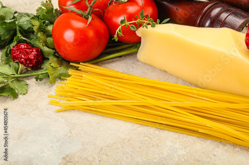 Raw Italian spaghetti heap with cheese