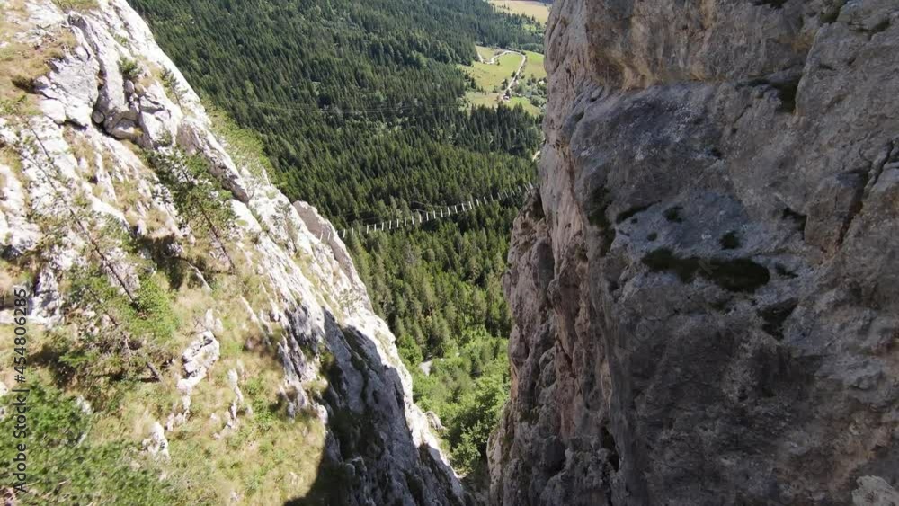 Aerial cinematic shot high speed sport fpv drone flying over natural mountain cliff surrounded Amazing nature rocky terrain with green vegetation and forest on cloudy day. Aerial cinematic shot high speed sport fpv drone flying over natural mountain cliff surrounded Amazing nature rocky terrain with green vegetation and forest on cloudy day.
