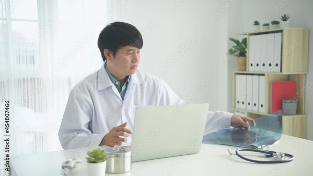Medical concept of 4k Resolution. The doctor looks at the patient's condition from the film X-ray. Medical concept of 4k Resolution. The doctor looks at the patient's condition from the film X-ray.