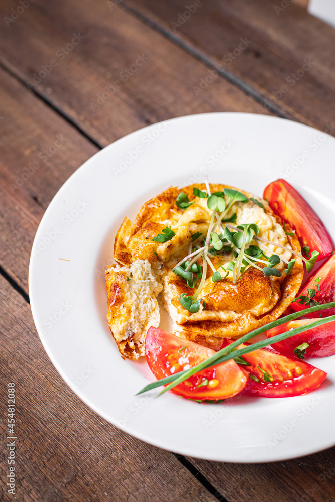 omelet with vegetables fresh breakfast fried eggs and tomato, cucumber fresh portion ready to eat meal snack on the table copy space food background rustic keto or paleo diet veggie omelet with vegetables fresh breakfast fried eggs and tomato, cucumber fresh portion ready to eat meal snack on the table copy space food background rustic keto or paleo diet veggie