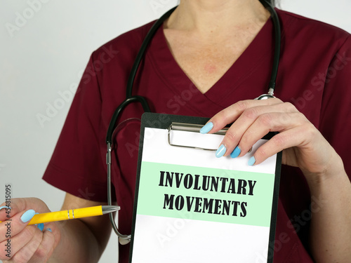 Healthcare concept meaning INVOLUNTARY MOVEMENTS with sign on the piece of paper. photo