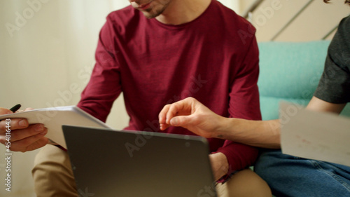 Two men are hard working and looking through documents