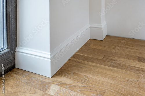 Detail of corner flooring with intricate crown molding and plinth. photo