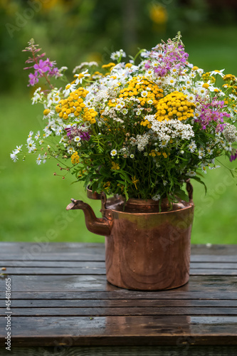 Wallpaper Mural Bouquet of wildflowers with daisies in an old copper teapot on a wooden table outdoors Torontodigital.ca