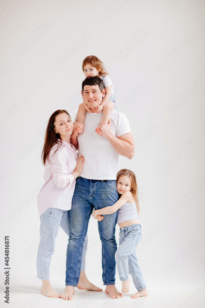 beautiful happy family in a white photo studio. parent-child relationship beautiful happy family in a white photo studio. parent-child relationship