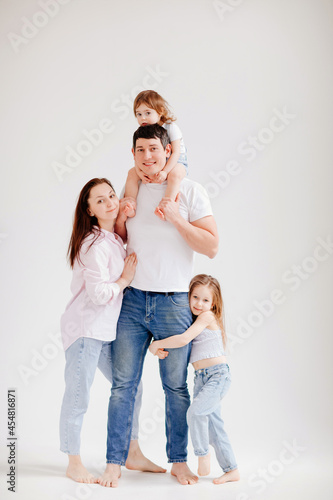 beautiful happy family in a white photo studio. parent-child relationship © andrey