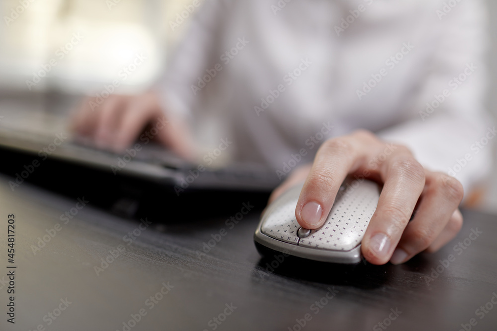close up of businesswoman using computer mouse