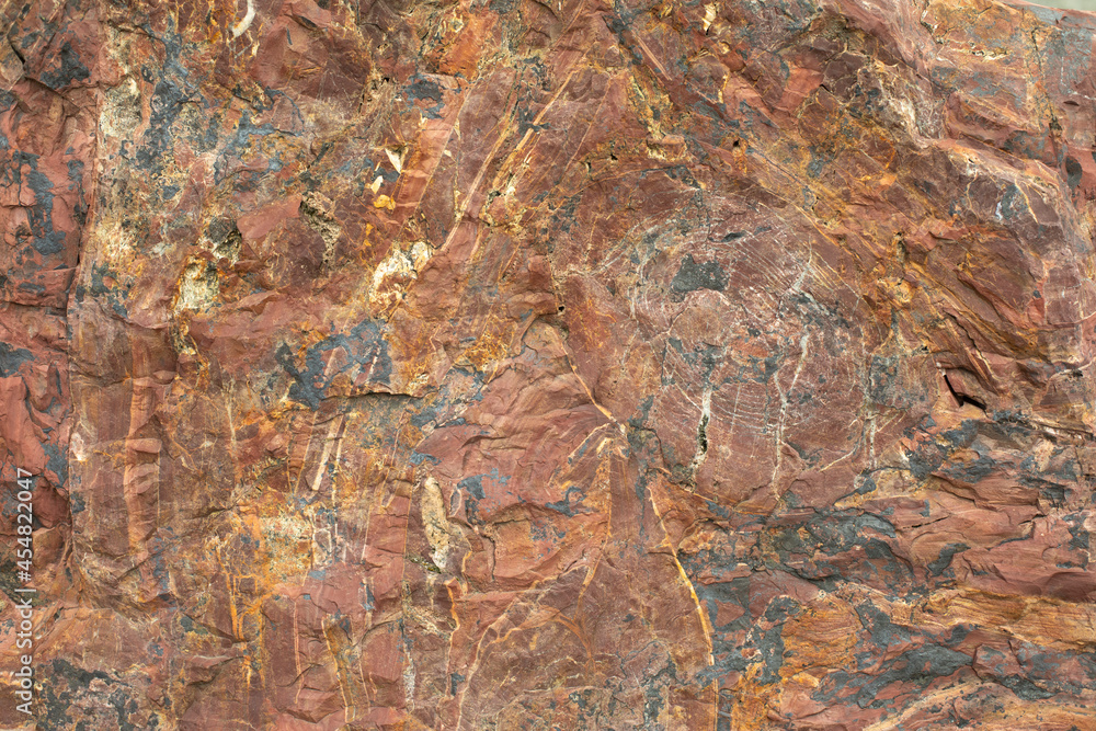 Granite texture. Red stone in detail. Natural background chipping rocks.