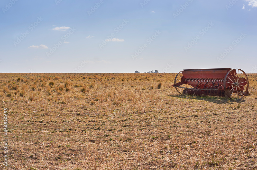 Fototapeta premium Grain seeder direct sowing system in field. Copy space