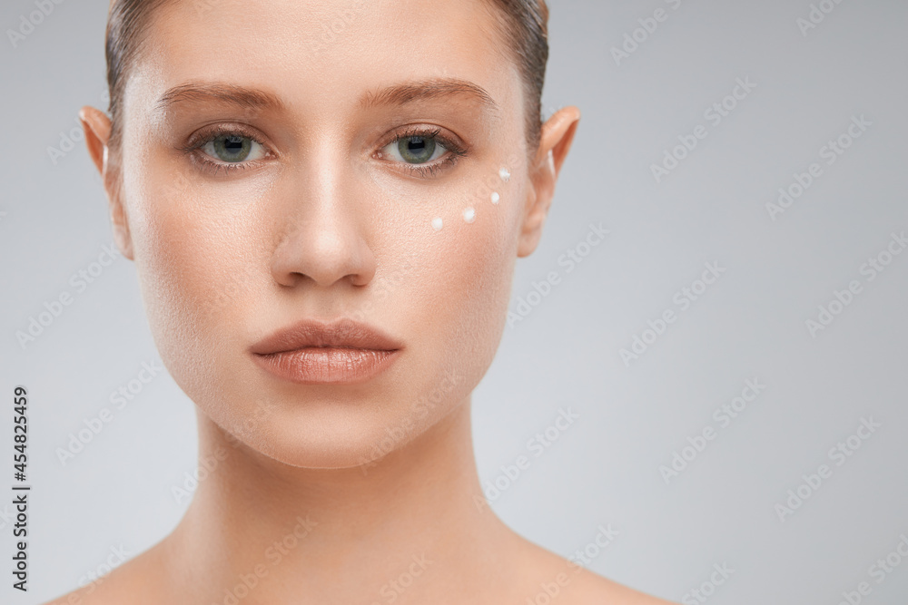 Attractive smiling young lady with cream on her face. Beauty photography Attractive smiling young lady with cream on her face. Beauty photography