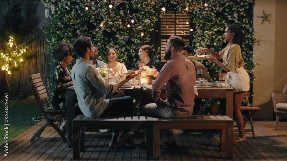 group of friends celebrating evening dinner party sharing homemade meal enjoying casual conversation having fun weekend reunion relaxing on calm summer night outdoors 4k footage group of friends celebrating evening dinner party sharing homemade meal enjoying casual conversation having fun weekend reunion relaxing on calm summer night outdoors 4k footage