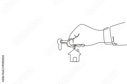 Single one line drawing landlord unlocks the house key for new home. Real estate. Female hand holding key from house isolated on white. Buying house. Modern continuous line draw design graphic vector photo
