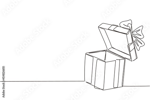 Single one line drawing open white gift box with ribbon and bow. Greeting present package. Decorative gift or cardboard box with bow. Modern continuous line draw design graphic vector illustration photo