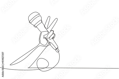 Continuous one line drawing child holding microphone on white background, closeup of hand. Mic with victory gesture. Karaoke kid sings song to microphone. Single line draw design vector illustration