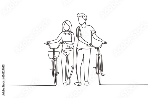 Single continuous line drawing cyclists walking down forest road with their bicycles on summer day. Young man and woman in love. Happy romantic married couple. One line draw graphic design vector