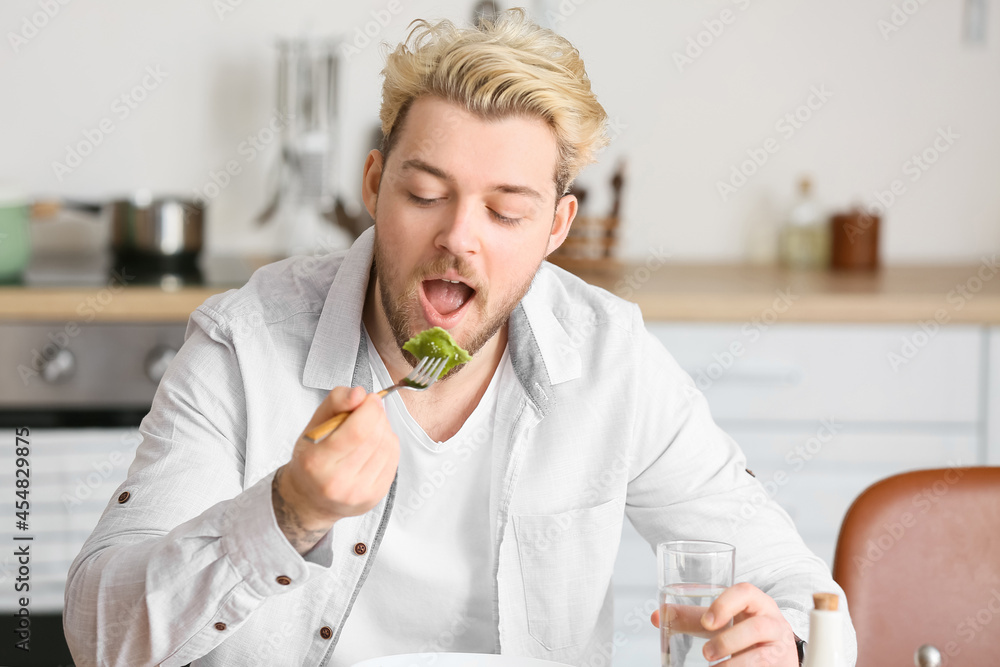 Young man eating tasty ravioli at home Young man eating tasty ravioli at home