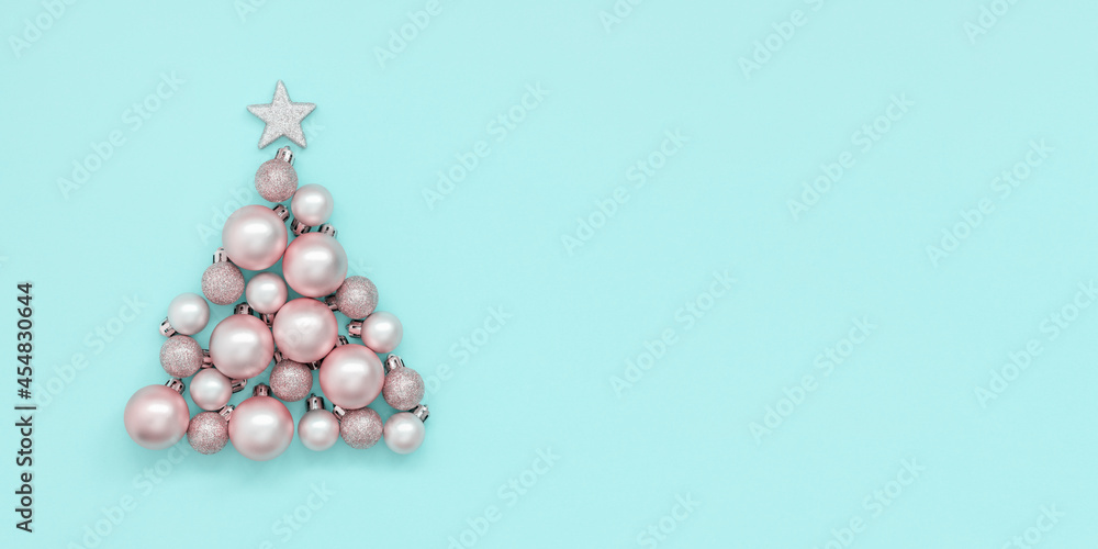 Blue christmas background with christmas tree made of pink christmas balls Blue christmas background with christmas tree made of pink christmas balls