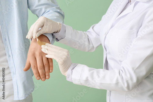 Doctor applying plaster ont...