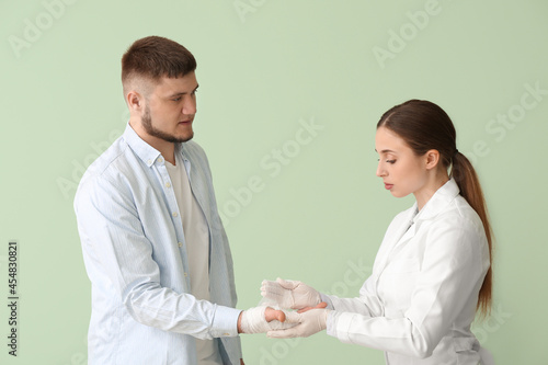 Doctor applying bandage ont...