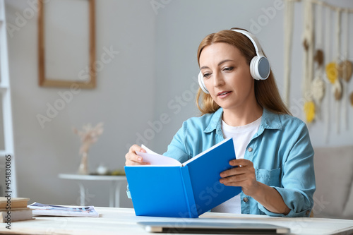 Mature woman with headphone...