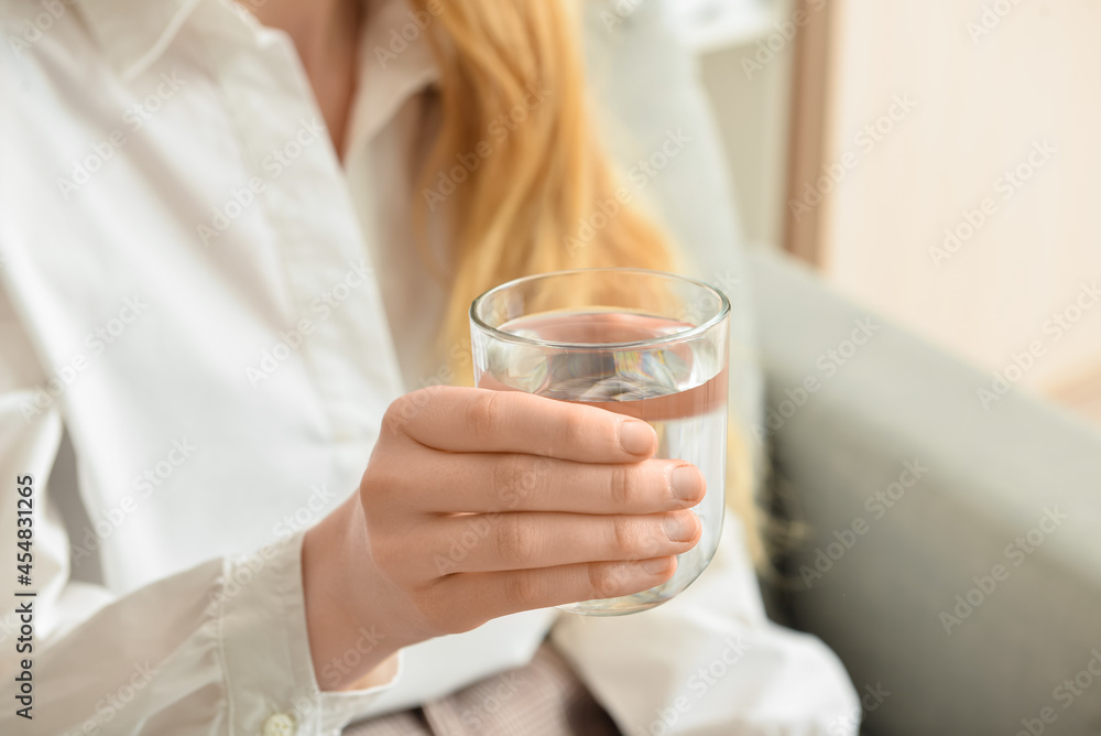 Woman with glass of fresh water in room, closeup Woman with glass of fresh water in room, closeup