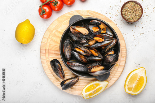Composition with tasty mussels on light background