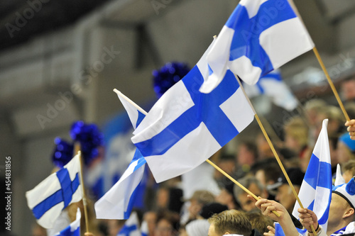 Finnish ice hockey fans waiving Finland flags in the lecture.