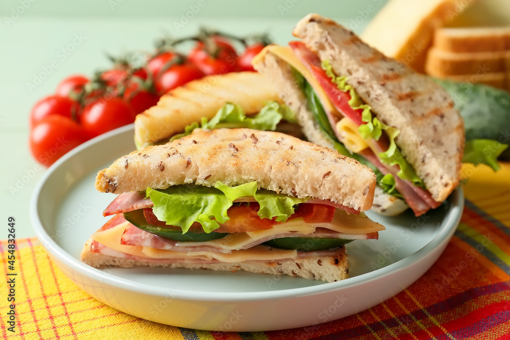 Plate with tasty sandwiches on table, closeup Plate with tasty sandwiches on table, closeup