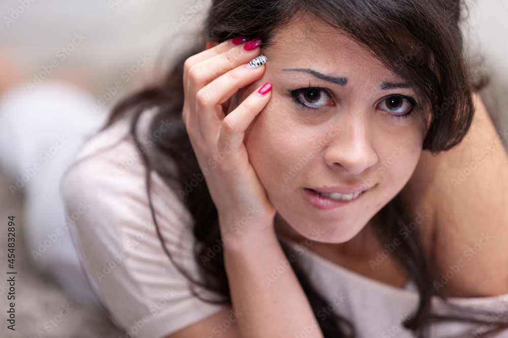 Thoughtful troubled young woman biting her lip Thoughtful troubled young woman biting her lip
